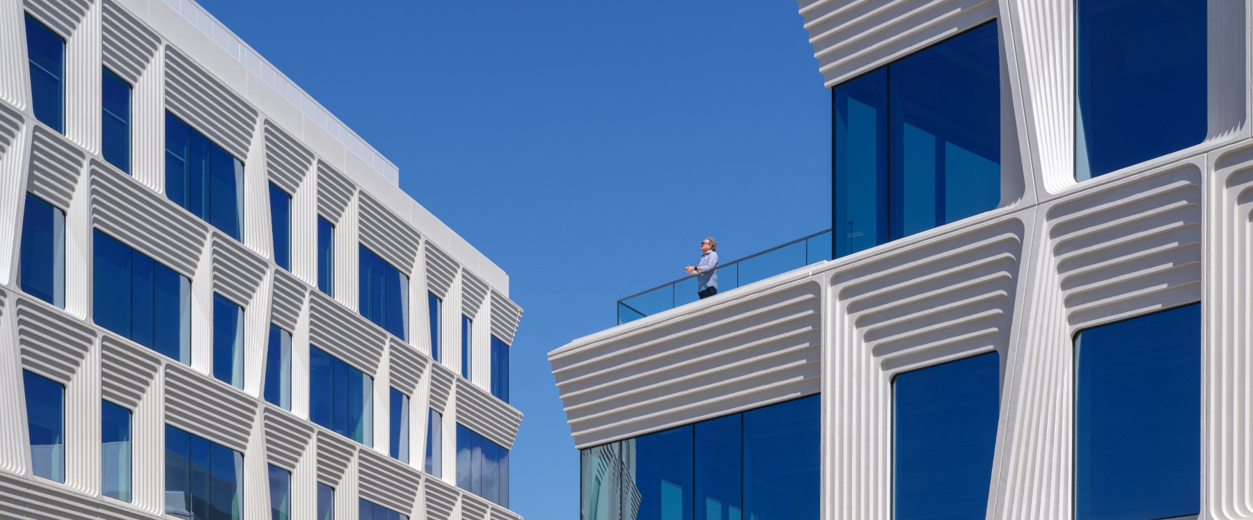 Flad Architects Breakthrough Properties Torrey View: outdoor view of person on balcony